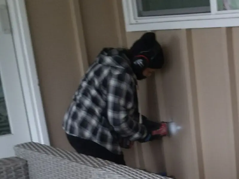 Professional electrician installing an exterior outlet in Celebration