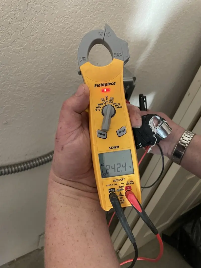 Voltage testing with clamp meter during Generator Installation in Celebration
